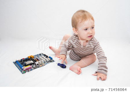 beautiful baby holding a bottle in the hand with shower gel, beside lies Baby cosmetic tubes on white isolated background	 71456064