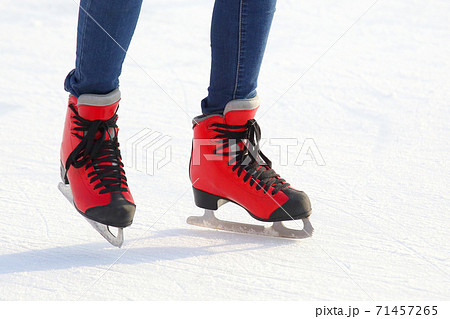Female legs in skates on an ice rink Female legs in skates on an ice rink 71457265