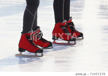 feet in red skates on an ice rink feet in red skates on an ice rink 71457270