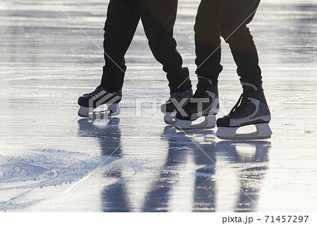 Legs of a man skating on an ice rink. Hobbies and sports. Vacations and winter activities Legs of a man skating on an ice rink. Hobbies and sports. Vacations and winter activities 71457297