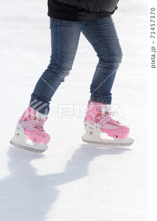 feet skating on the ice rink 71457370