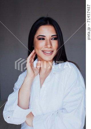 Beautiful fashionable brunette woman in white portrait shirt 71457487