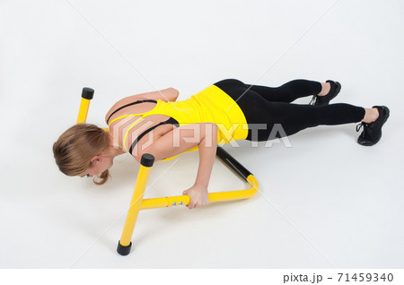Woman doing exercises with high yellow floor bars on a white background 71459340