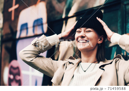 Close-up portrait Beautiful elegant woman wearing beige coat and black hat. Trendy casual outfit. Soft selective focus. grain Close-up portrait Beautiful elegant woman wearing beige coat and black hat. Trendy casual outfit. Soft selective focus. grain 71459588