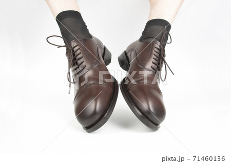 Male legs in socks and brown classic shoes on a white background 71460136
