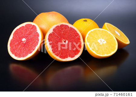 Cut fresh oranges and grapefruits on a dark background Cut fresh oranges and grapefruits on a dark background 71460161
