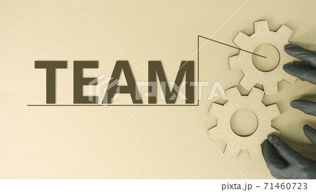 Team word at cogwheels made from recycled cardboard Team word at cogwheels made from recycled cardboard 71460723
