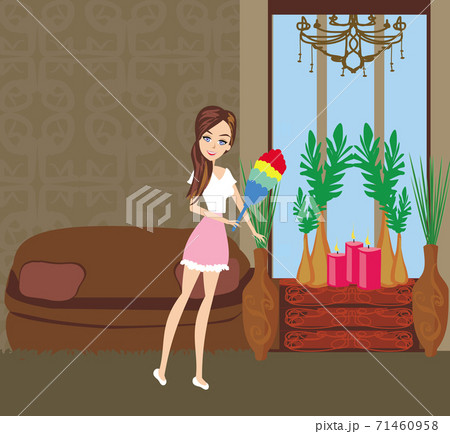 Maid holding duster brush in an elegant room 71460958