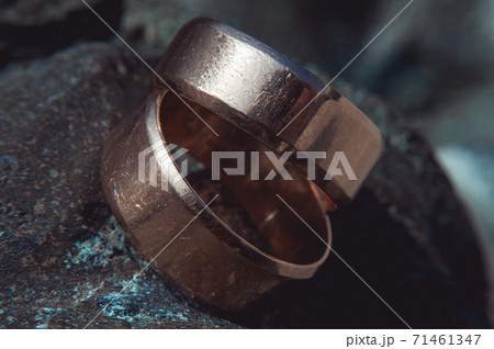 scratched two wide gold wedding rings on stone scratched two wide gold wedding rings on stone 71461347