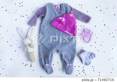 Festive Composition with baby girl accessories on white background with confetti. flat lay and top view Festive Composition with baby girl accessories on white background with confetti. flat lay and top view 71462716
