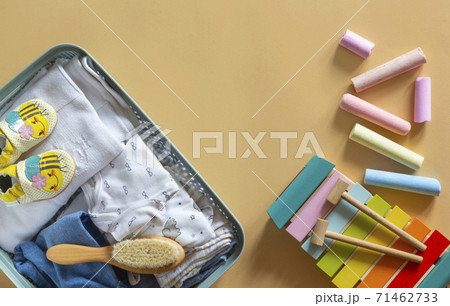 Donation box with Baby Unisex neutral clothing and donation accessories on beige background. Flat lay and copy space Donation box with Baby Unisex neutral clothing and donation accessories on beige background. Flat lay and copy space 71462733