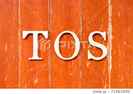 Alphabet letter in word TOS (abbreviation of Terms of service) on old red color wood plate background 71463000