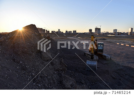 Excavator work at constrruction site on sunset background. Excavator work at constrruction site on sunset background. 71465214