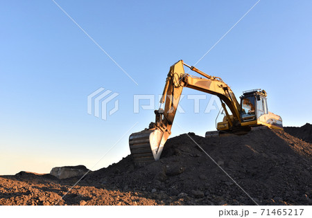 Excavator working on earthmoving at open pit mining.  71465217