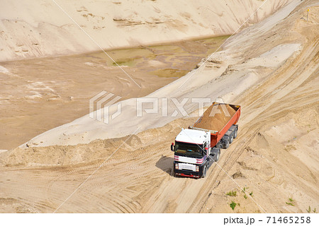 Truck with tipper semi trailer transported sand from the quarry. Dump truck  71465258