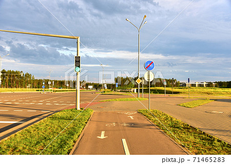 Road sign - the end of cycle path in city at pedestrian zone. Green traffic light signal Road sign - the end of cycle path in city at pedestrian zone. Green traffic light signal 71465283