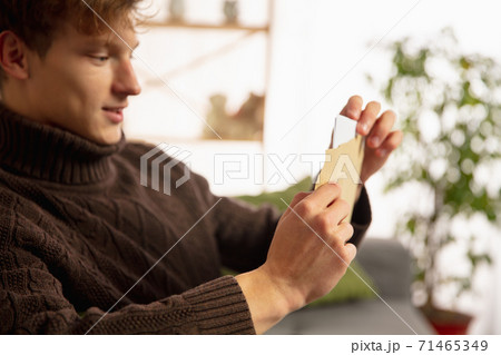 Man opening, recieving greeting card for New Year and Christmas 2021 from friends or family Man opening, recieving greeting card for New Year and Christmas 2021 from friends or family 71465349