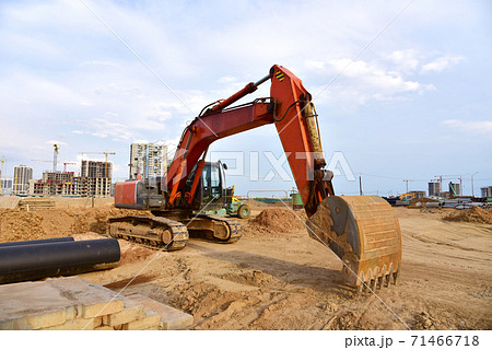 Large construction site with tower cranes and buildings on sunset background 71466718