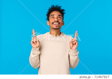 Dreamy excited and happy young man contemplate wonderful fireworks on new year holiday, watching entertaining scene. Attractive african american guy looking and pointing up, smiling happily 71467927