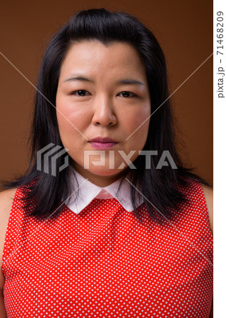 Face of beautiful overweight Asian woman looking at camera Face of beautiful overweight Asian woman looking at camera 71468209