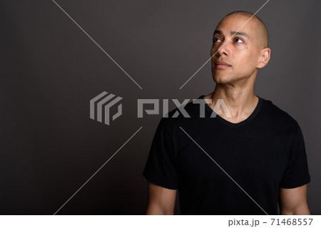 Handsome bald man thinking and looking up Handsome bald man thinking and looking up 71468557