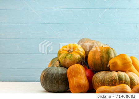 Assortment of small pumpkins on wooden background Assortment of small pumpkins on wooden background 71468682