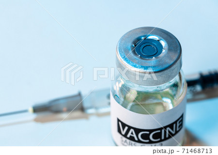 Covid-19 vaccine bottle with a syringe on lab table 71468713
