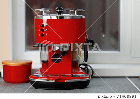 Red domestic coffee machine on kitchen counter 71468891