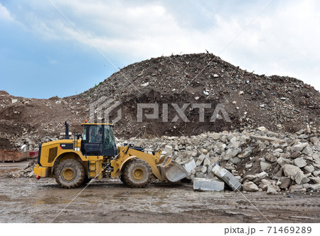 Front end loader at landfill for disposal of construction waste. Front end loader at landfill for disposal of construction waste. 71469289