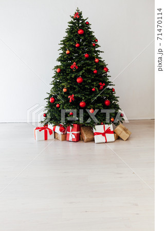 Christmas tree pine with red decor with gifts interior postcard for the new year 71470114