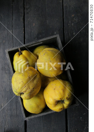 Fresh quince on a vintage table. Food background. 71470830