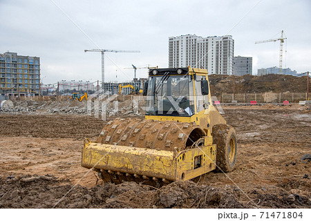 Soil Compactor at construction site. Vibration single-cylinder road roller for leveling soil,  71471804