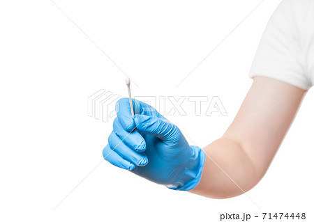 doctor hand in a blue sterile glove holds to give cotton swab for sampling smear analysis from the oral cavity for a virus test, mock up medical theme isolated on white background with copy space. doctor hand in a blue sterile glove holds to give cotton swab for sampling smear analysis from the oral cavity for a virus test, mock up medical theme isolated on white background with copy space. 71474448