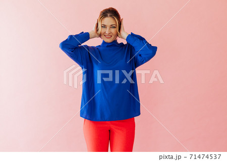 Beautiful woman covers her ears with her hands from the noise 71474537