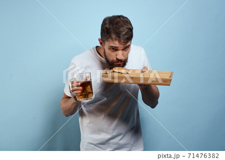 Cheerful man mug of beer fast food diet food lifestyle blue background alcohol 71476382
