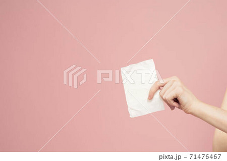 Laying in packaging in female hands on a pink background cropped view hygiene clean appearance Laying in packaging in female hands on a pink background cropped view hygiene clean appearance 71476467