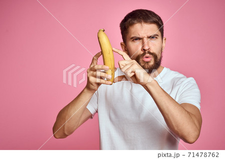 bearded man with banana in hand on pink background fun emotions model bearded man with banana in hand on pink background fun emotions model 71478762