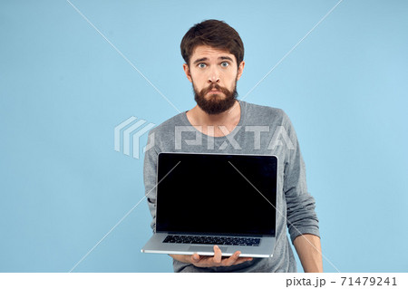 Bearded man laptop in hand internet wireless technology emotions blue background 71479241