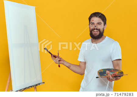 Male artist palette easel drawing hobby lifestyle creativity yellow background Male artist palette easel drawing hobby lifestyle creativity yellow background 71479283