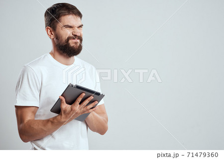 emotional man with tablet in hand touch screen new technologies light background cropped view Copy Space emotional man with tablet in hand touch screen new technologies light background cropped view Copy Space 71479360