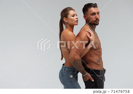 Muscular man hugging topless woman 71479758