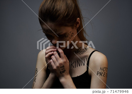 Woman with inscriptions on the body frustration and dissatisfaction emotions lifestyle gray background 71479946