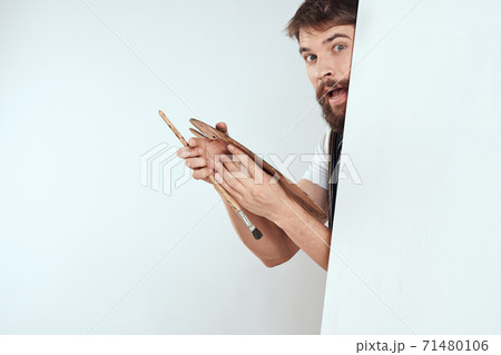 Male artist hiding behind an easel palette drawing art 71480106