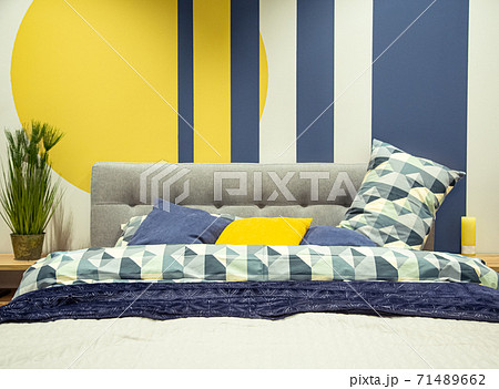 Modern bedroom interior in blue and yellow tones. 71489662