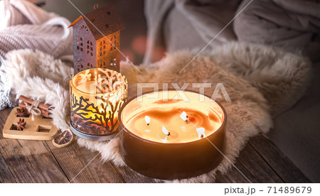 home still life in the interior with beautiful candles, on the background of a cozy home decor home still life in the interior with beautiful candles, on the background of a cozy home decor 71489679