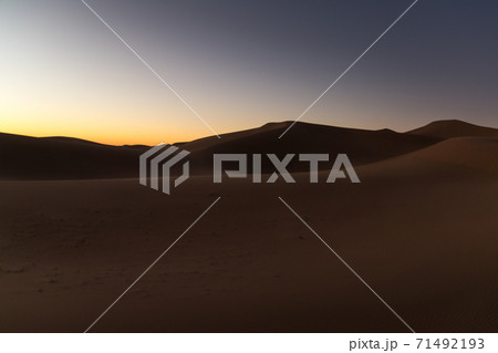 Dreamy desert concept at Twilight of dawn at desert dune of Erg Chigaga, at the gates of the Sahara. Morocco. Concept of travel and adventure Dreamy desert concept at Twilight of dawn at desert dune of Erg Chigaga, at the gates of the Sahara. Morocco. Concept of travel and adventure 71492193