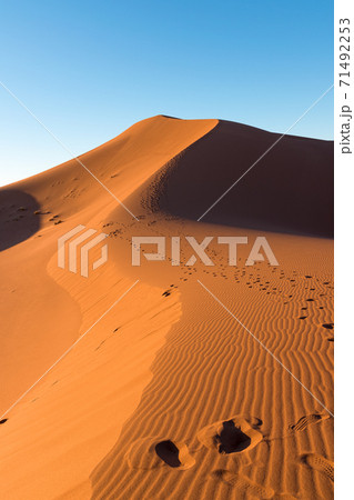 Wide angle shoot of footpath in desert dunes of Erg Chigaga.The gates of the Sahara, at sunrise. Morocco. Concept of travel and adventure Wide angle shoot of footpath in desert dunes of Erg Chigaga.The gates of the Sahara, at sunrise. Morocco. Concept of travel and adventure 71492253