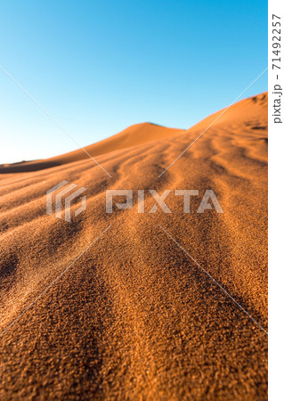 Daytime close-up desert dunes of Erg Chigaga, at the gates of the Sahara. Morocco. Concept of travel and adventure. Daytime close-up desert dunes of Erg Chigaga, at the gates of the Sahara. Morocco. Concept of travel and adventure. 71492257