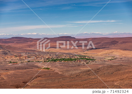 Daytime wide angle shoot of a town and the Atlas Mountains in the background, Morocco. Daytime wide angle shoot of a town and the Atlas Mountains in the background, Morocco. 71492324