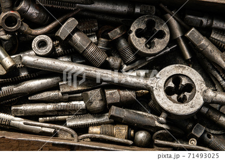 Old vintage iron toolbox full of drills and threading die tools as background 71493025